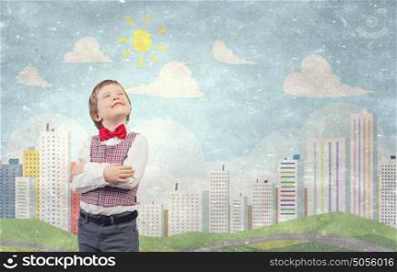 He is little sir. Portrait of little boy with hands folded on chest