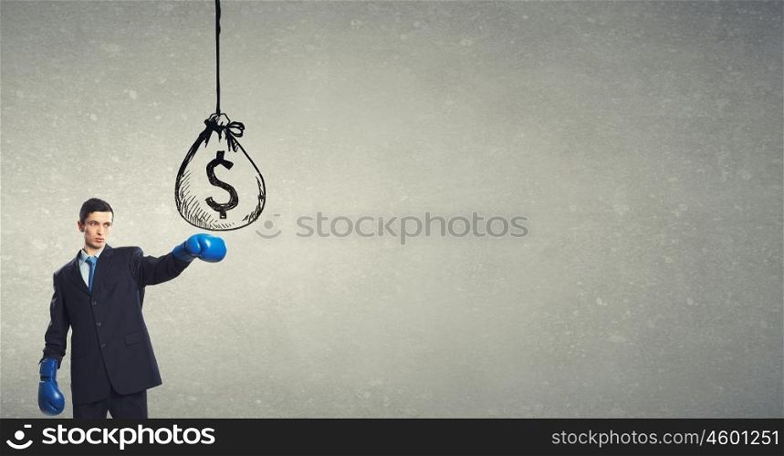 He is ready to fight for success. Young businessman in boxing gloves punch money bag