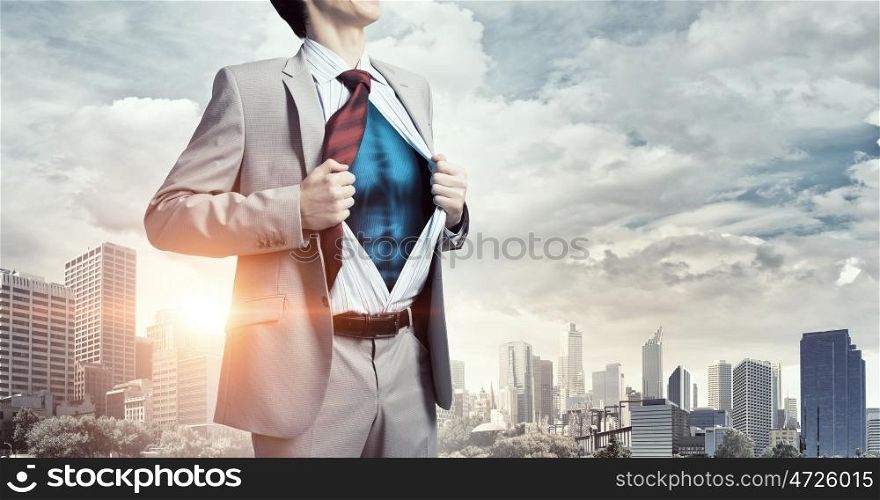 He is super manager. Office worker opening his shirt on chest like superhero