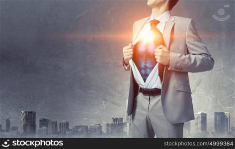 He is super manager. Office worker opening his shirt on chest like superhero