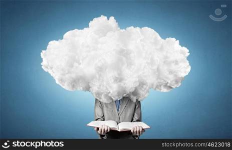 He is up in the clouds. Young businessman with book in hands and cloud instead of head