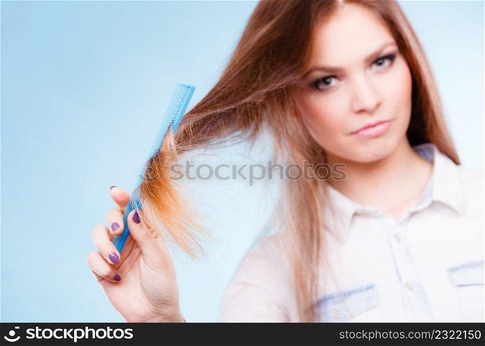 Hea<hy look concept. Girl combing brushing her hair by using plastic comb. Young woman taking care of everyday hygie≠and natural beauty.. Long haired woman combing her hair.