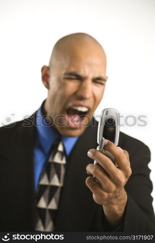 Head and shoulder portrait of African American man in suit yelling at cellphone.