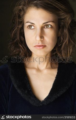 Head and shoulder portrait of pretty brunette woman.