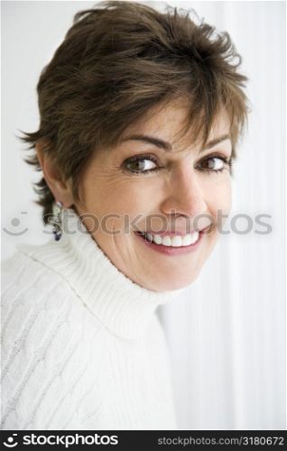 Head and shoulder portrait of pretty Caucasian woman smiling.