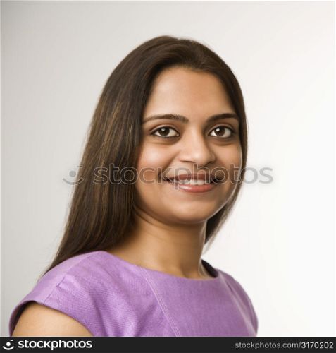 Head and shoulder portrait of pretty Indian woman on white background.