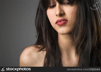 Head and shoulder portrait of pretty young woman with long black hair.