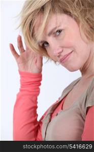 Head and shoulder studio shot of woman with funky short blonde hair