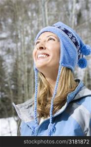 Head and shoulder view of attractive smiling mid adult Caucasian blond woman wearing blue ski clothing.