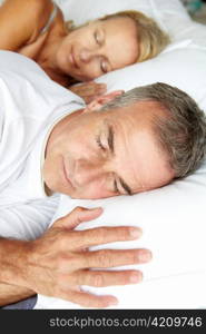 Head and shoulders mid age couple sleeping