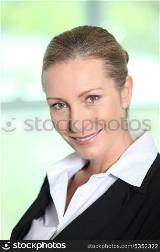 Head and shoulders of a smiling female executive