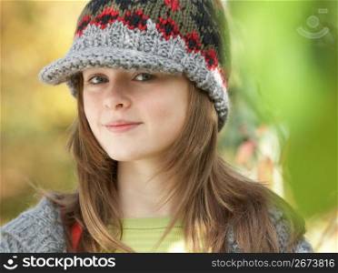 Head And Shoulders Of Young Girl In Autumn Woodland