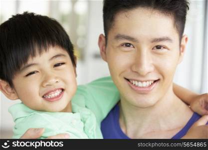 Head And Shoulders Portrait Of Chinese Father And Son