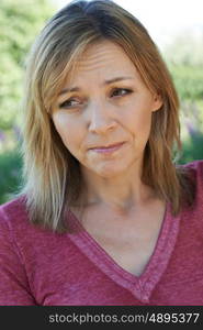 Head And Shoulders Portrait Of Concerned Mature Woman