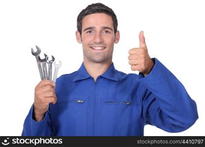 head and shoulders portrait of plumber holding wrenches all smiles