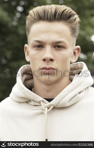 Head And Shoulders Portrait Of Serious Teenage Boy