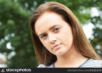 Head And Shoulders Portrait Of Serious Teenage Girl