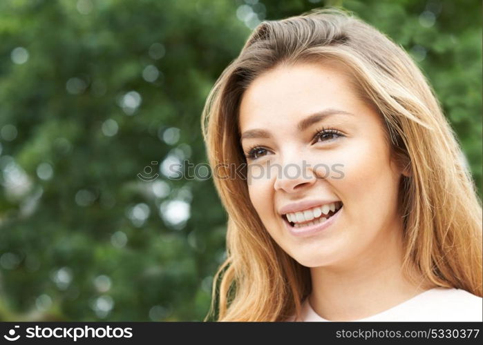 Head And Shoulders Portrait Of Smiling Teenage Girl