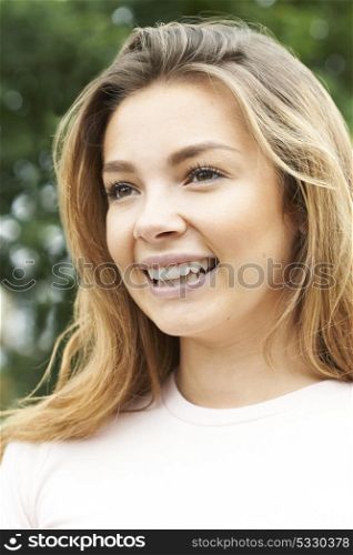 Head And Shoulders Portrait Of Smiling Teenage Girl