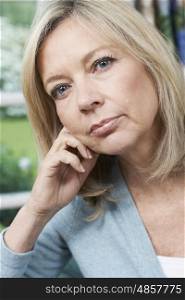 Head And Shoulders Portrait Of Thoughtful Mature Woman At Home