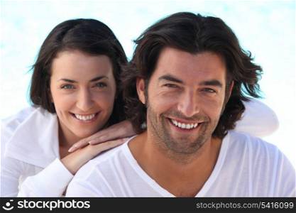 Head and shoulders shot of a well matched couple in white
