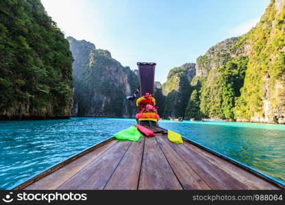 head long tail boat on the sea and cliff rock mountain background high season tourists summer holiday at phi phi island kra bi Thailand