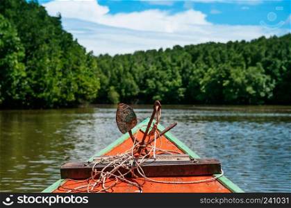 Head of colourful Thai fishing boat with iron rustic anchor and rope, Koh Chang Mangrove forest view