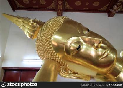 Head of golden sleeping Buddha in temple, Chedi Phra Pathom, Thailand