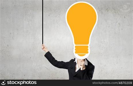 Head of ideas. Unrecognizable businesswoman hiding her face behind bulb shaped mask