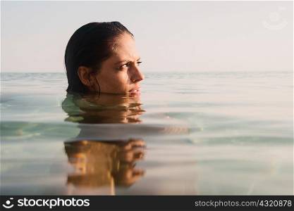 Head portrait of young woman in sea