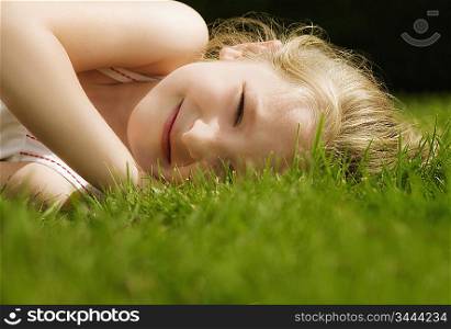 Head shot of a girl lying on a lawn
