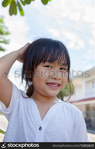 head shot of lovely asian children smiling face outdoor