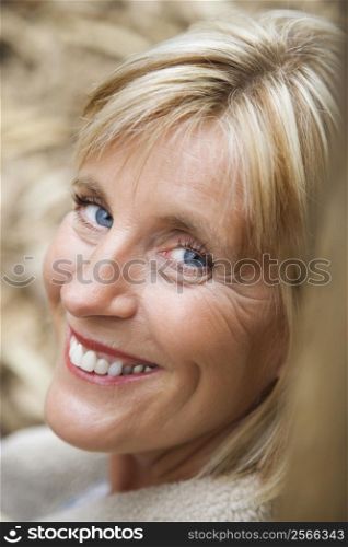 Head shot of middle-aged Caucasian woman smiling.