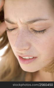 Head shot of woman scowling