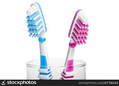 Head Toothbrush standing in a glass on a white background