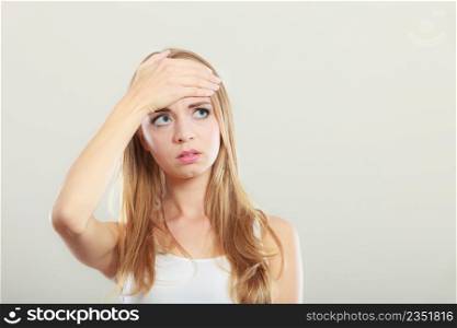 Headache, migraine and stress. Worried upset woman suffering from head pain or having high temperature.