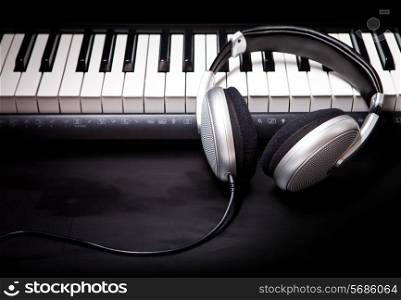 Headphones on musical synthesizer keyboard. Headphones on electronic piano