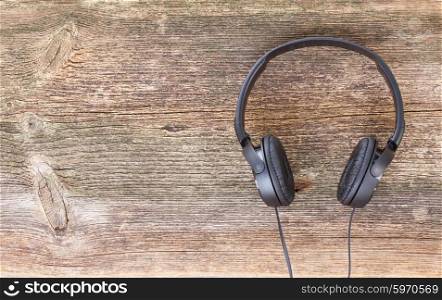 headphones on wood . big black headphones on aged wooden background