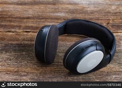 headphones on wood . big vintage headphones on aged wooden background