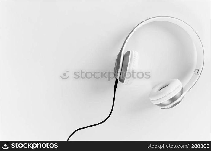 Headphones with black cable On a gray background. Relaxation concept of music.