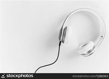 Headphones with black cable On a gray background. Relaxation concept of music.