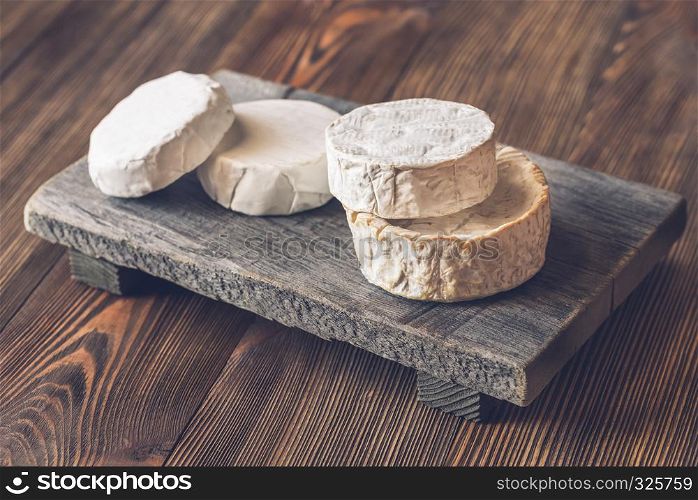 Heads of Camembert on the wooden board