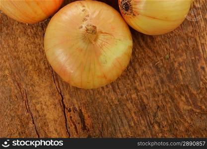Heads of some onion on wooden board