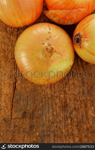 Heads of some onion on wooden board