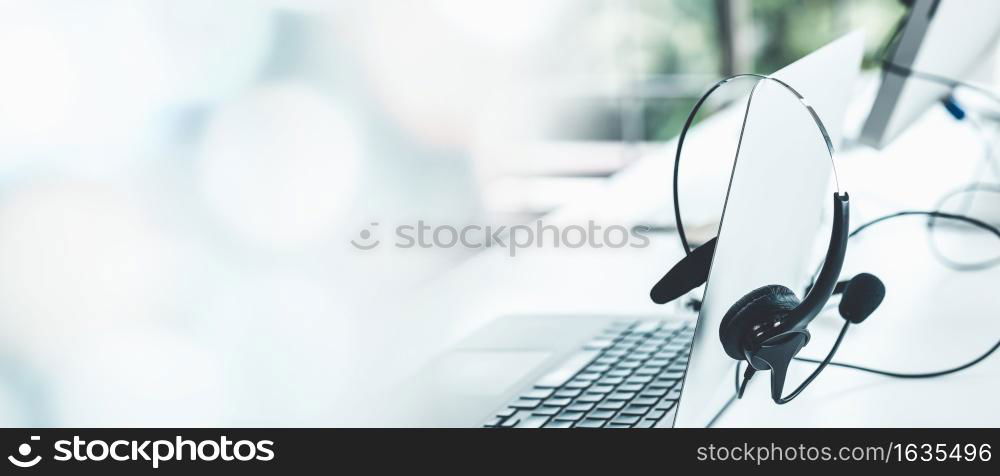 Headset and customer support equipment at call center ready for actively service . Corporate business help desk and telephone assistance concept .. Headset and customer support equipment at call center ready for actively service