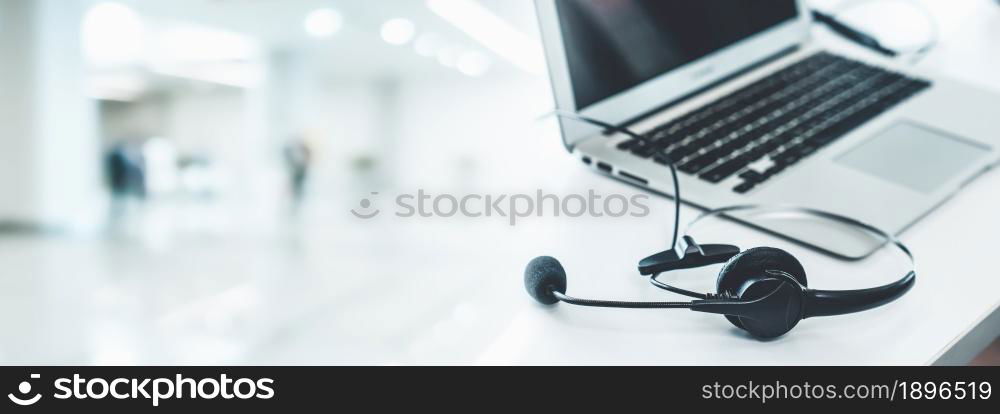 Headset and customer support equipment at call center ready for actively service . Corporate business help desk and telephone assistance concept .. Headset and customer support equipment at call center ready for actively service