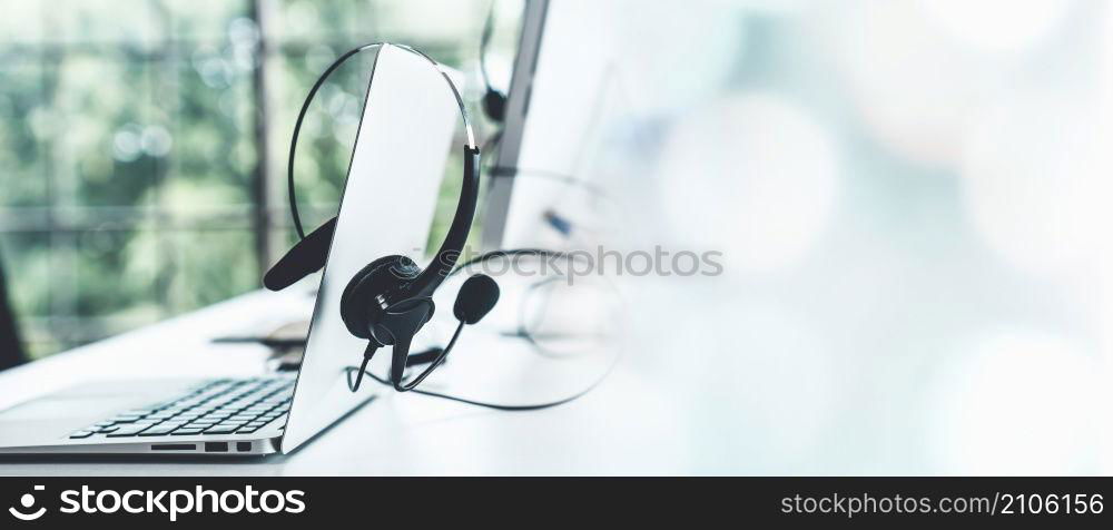 Headset and customer support equipment at call center ready for actively service . Corporate business help desk and telephone assistance concept .. Headset and customer support equipment at call center ready for actively service