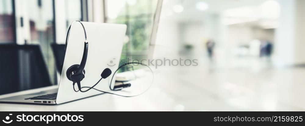 Headset and customer support equipment at call center ready for actively service . Corporate business help desk and telephone assistance concept .. Headset and customer support equipment at call center ready for actively service