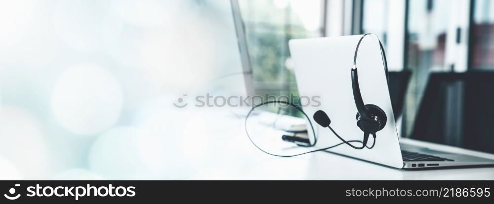 Headset and customer support equipment at call center ready for actively service . Corporate business help desk and telephone assistance concept .. Headset and customer support equipment at call center ready for actively service