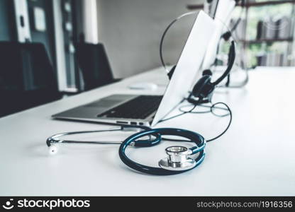 Headset and doctor equipment at clinic ready for actively support for patient by online video call . Concept of telehealth and telemedicine service .. Headset and doctor equipment at clinic ready for actively support for patient